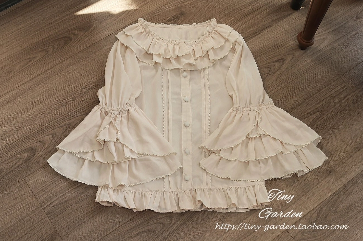 Vintage ruffled lolita blouse construction detail showing precise ruffled collar architecture and delicate bell sleeve layering, quality craftsmanship and seam construction close-up