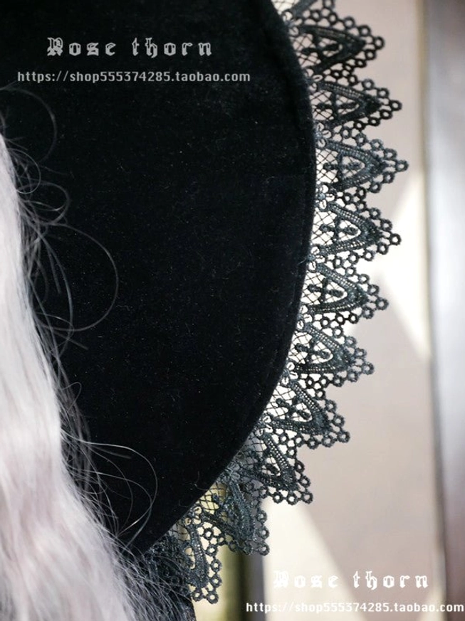 Close-up detailed view black velvet witch hat brim with water-soluble lace cross pattern border texture detail