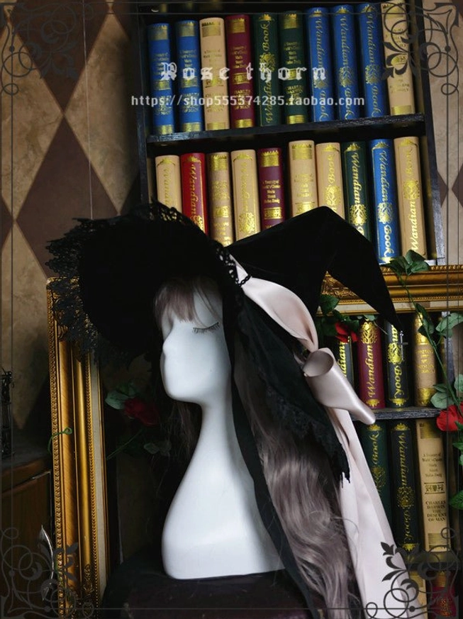 Black velvet sacred cross witch hat front view pointed silhouette metal cross finial detail display