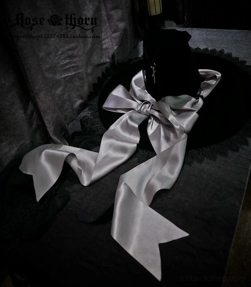 Back close-up view black velvet witch hat with silver-gray satin bow hanging ribbon straps detail display