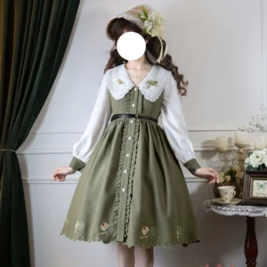 Sage green classic Lolita OP dress with three-tiered floral embroidered scalloped collar front view full body standing pose vintage home setting