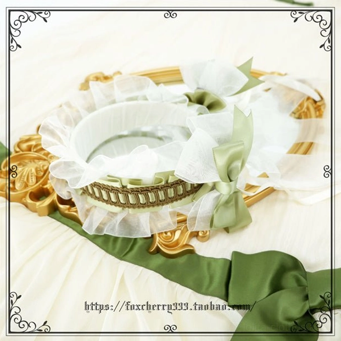 Sage green Lolita bow headdress detail shot showing pearl beads silk ribbon and delicate lace embellishments with Victorian aesthetic