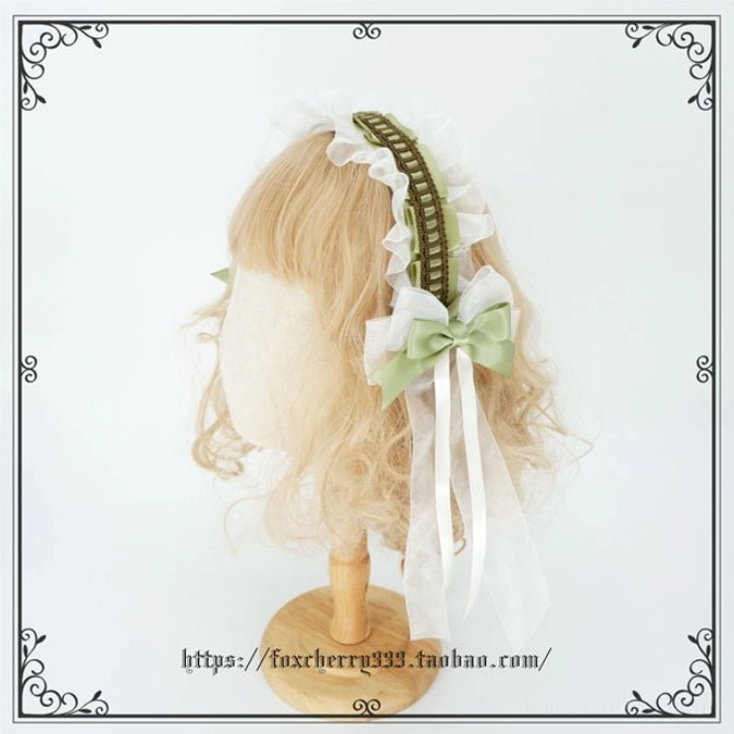 Sage green Lolita bow hair ornament displaying intricate pearl trim sheer tulle overlay and Victorian-inspired ruffled silk construction