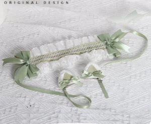 Sage green lolita hairband with detachable cat ear clips flat lay product showcase featuring white ruffled lace embroidered mesh strip and satin ribbon bow