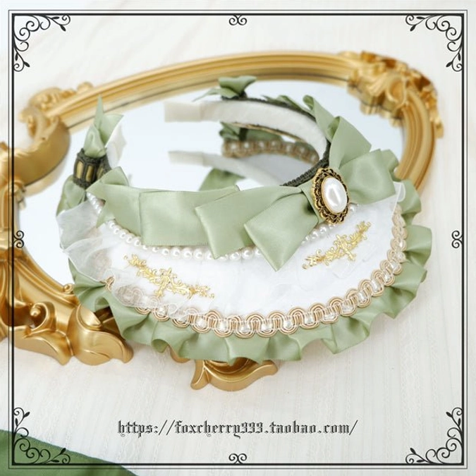 Sage green Lolita hairband accessory displayed flat showing scalloped edge design pearl center ornament and satin bow embellishments