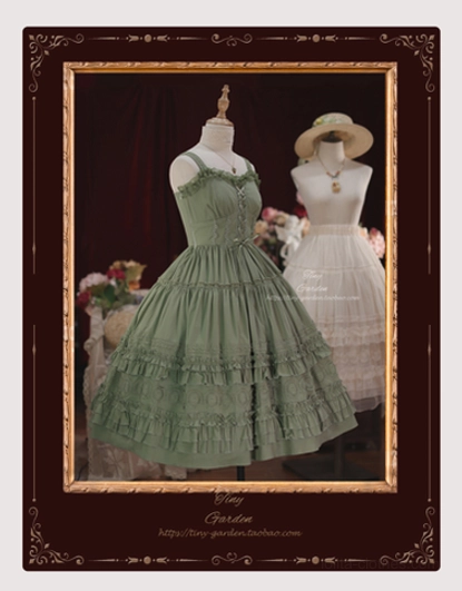 Sage green lolita JSK dress with matching half slip front full display showing ruffled sweetheart neckline spaghetti straps tiered ruffled skirt in vintage gilt frame backdrop with dark red curtains and floral ornaments