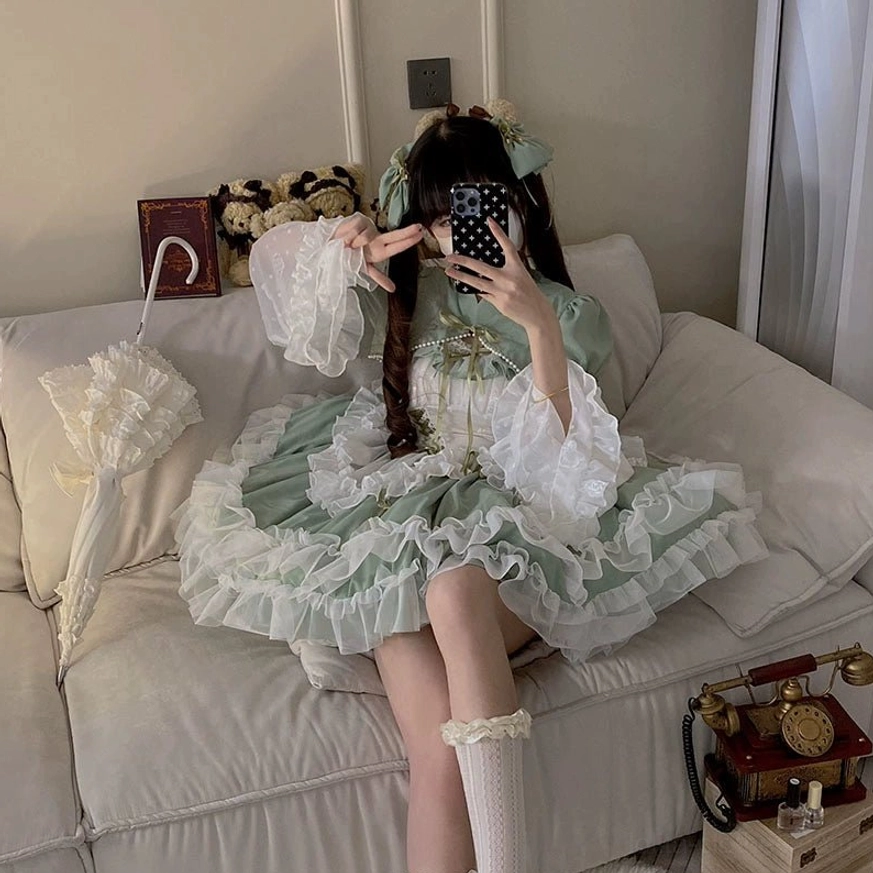 Sage green wedding lolita JSK dress photographed in natural lighting showing true color tone, fabric sheen, and elegant presentation of plus-size bridal jumper skirt