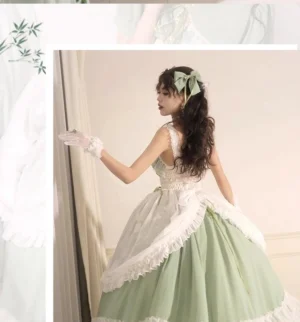 Side back full-body view of sage green lolita wedding dress JSK showing sheer white overlay, layered ruffled petticoat, matching bow, and lace glove details