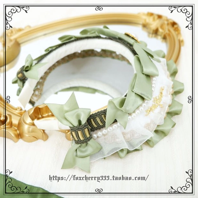 Sage green Lolita mini top hat headdress showing front-facing elevated view with full crown details pearl accents and ruffled base