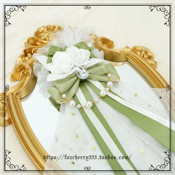 Sage green Lolita mini top hat headdress close-up angle highlighting texture details pearl ornament placement and decorative ribbon wrapping