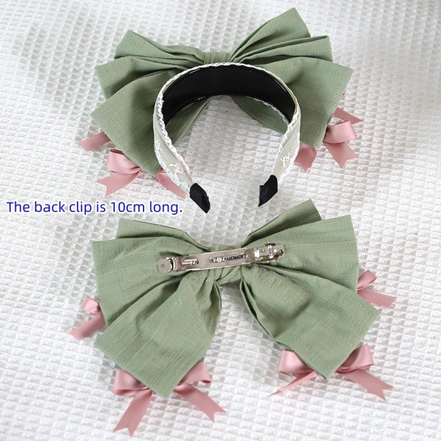 Sage green bow hair accessories set for lolita fashion including headband and hair clip with pink satin accents flat lay display white waffle texture