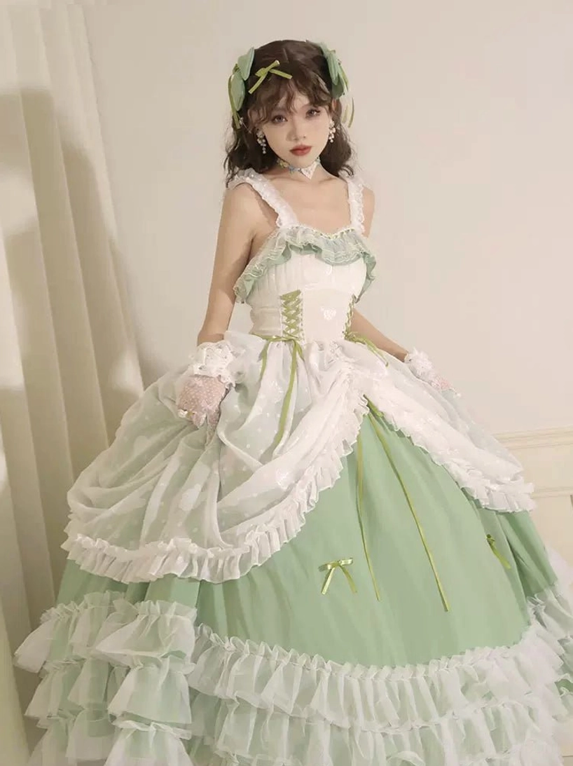 Front full-body view of sage green plus size wedding lolita JSK jumper skirt with ruffled trims, corset bodice, layered tiered skirt with small bow accents, and adjustable elastic straps