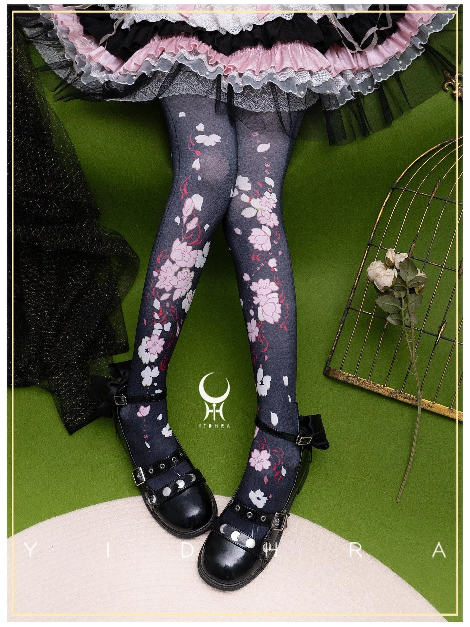 Dark sakura print Lolita pantyhose 120D side view showing ankle straps with pink-black Lolita skirt and black buckle bow shoes detailed leg perspective