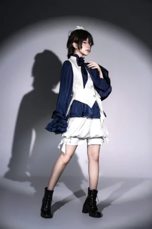 Side profile view of sapphire Ouji prince blouse showing ruffled hem with black lace trim, fitted waist construction, and flowing long sleeves on lolita fashion model