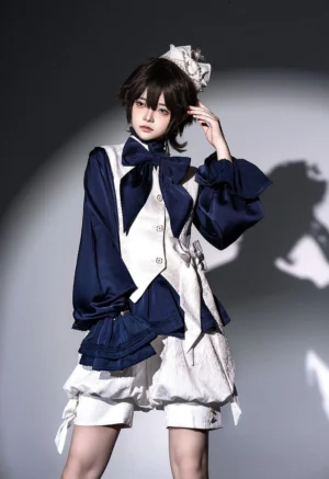 Sapphire Ouji Lolita blouse with detachable bow tie worn by model in front three-quarter pose, showcasing stand collar, ruffled cuffs, and cinched waist silhouette with navy bishop sleeves