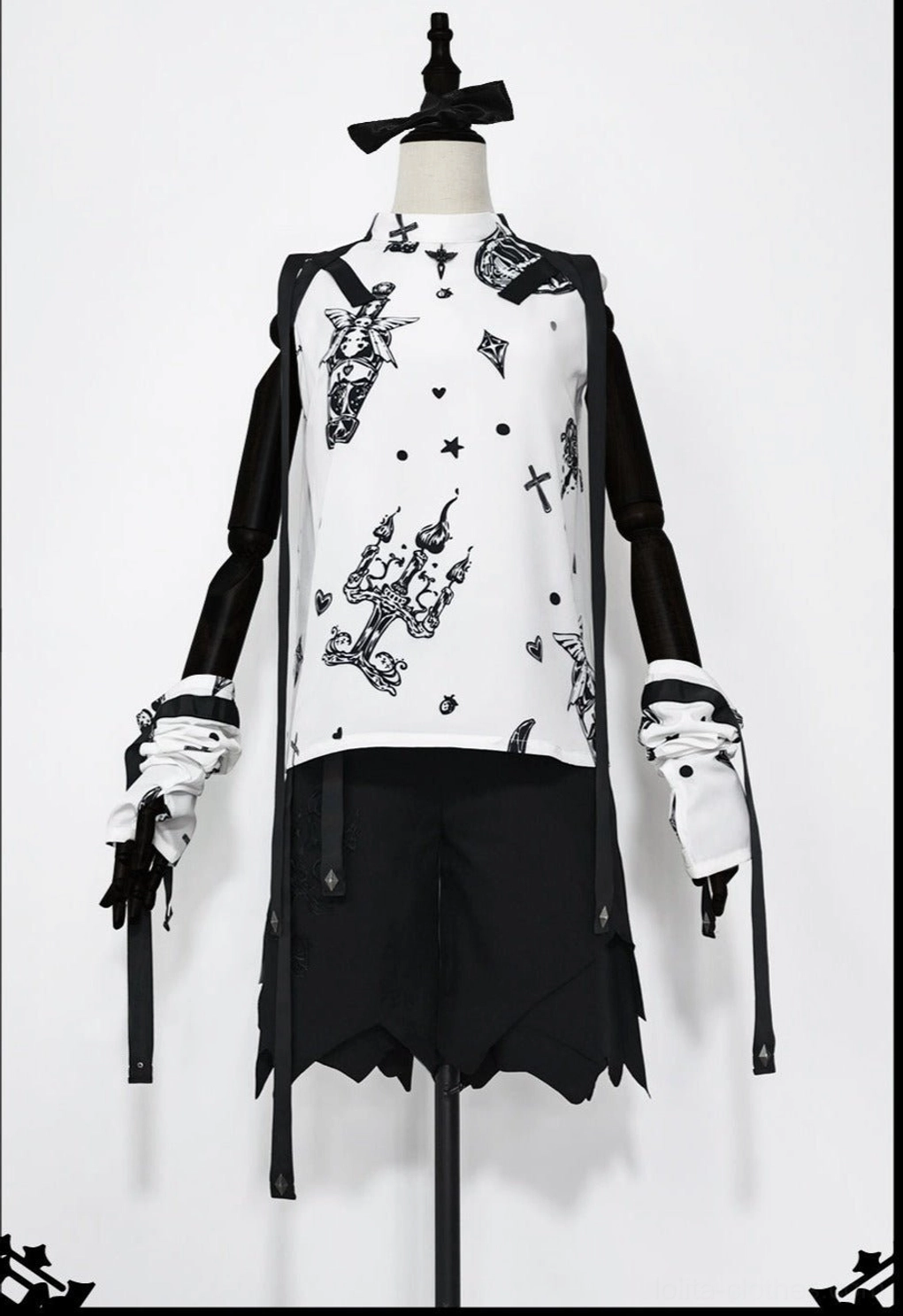 Close-up studio detail of Shadow Story gothic lolita sleeveless shirt showing retro black and white strawberry wing print pattern, black decorative straps, and refined construction