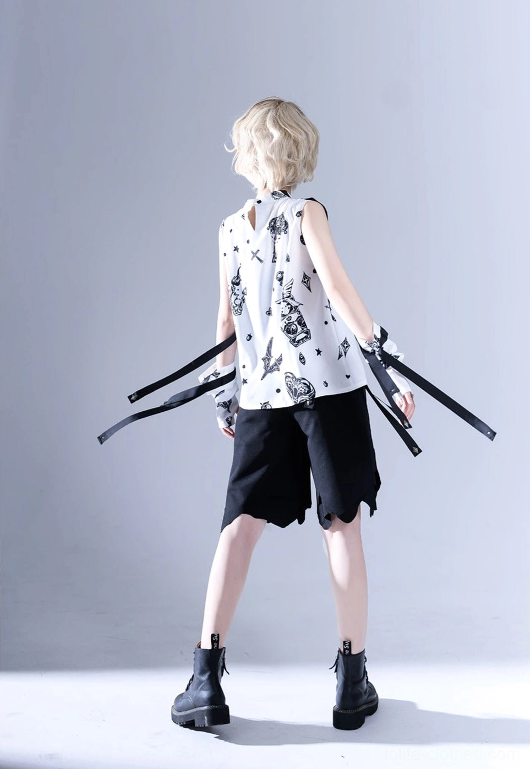 Back view of black and white Ouji lolita sleeveless shirt showing the rear fit, waist hanging decorative straps, and construction quality of the gothic summer top