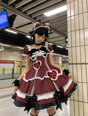Red-black plaid vintage lolita one-piece dress three-quarter view heart appliques ruffled lace edges large waist bow square neckline