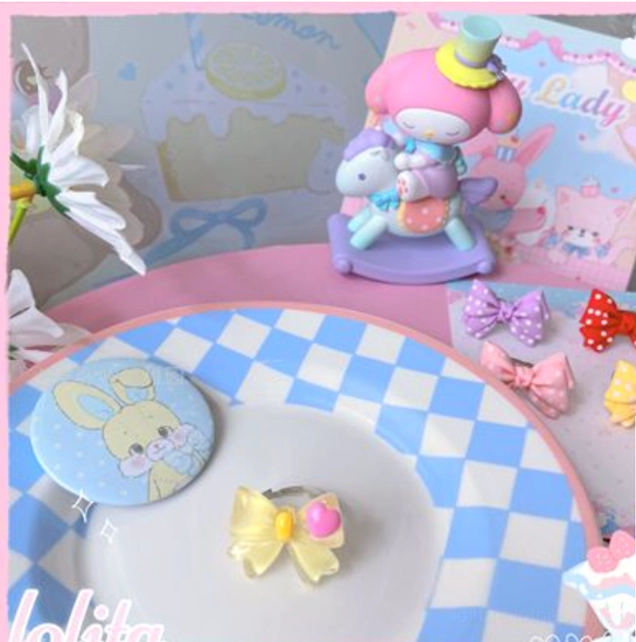 Fine shimmery blue iridescent lolita bowknot ring with magical ethereal quality perfect for fantasy-inspired lolita fashion photoshoots and special events