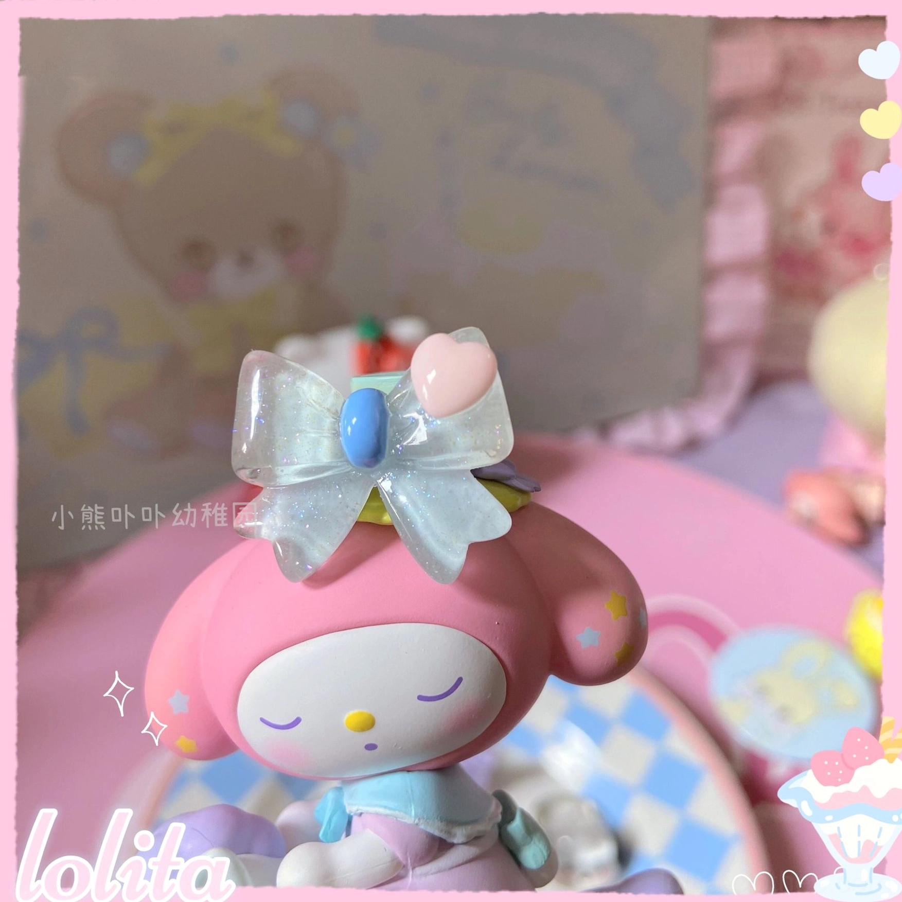 Translucent silver shimmery bowknot decorative accessory with blue and pink heart embellishments displayed on My Melody Sanrio figurine showing sweet lolita style