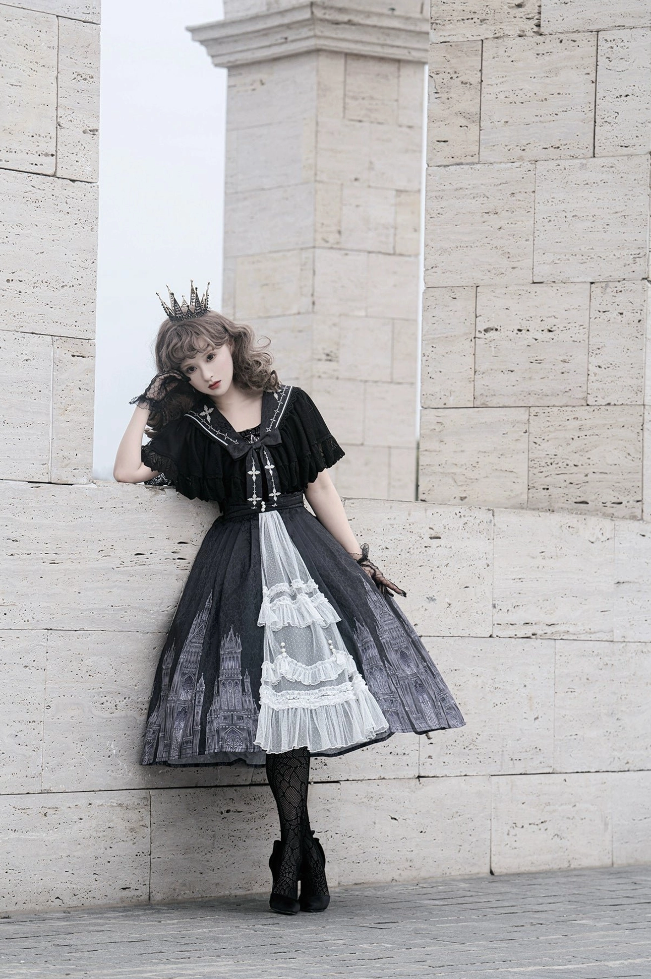 Gothic Lolita jumper skirt three-quarter side view stone building outdoor photoshoot