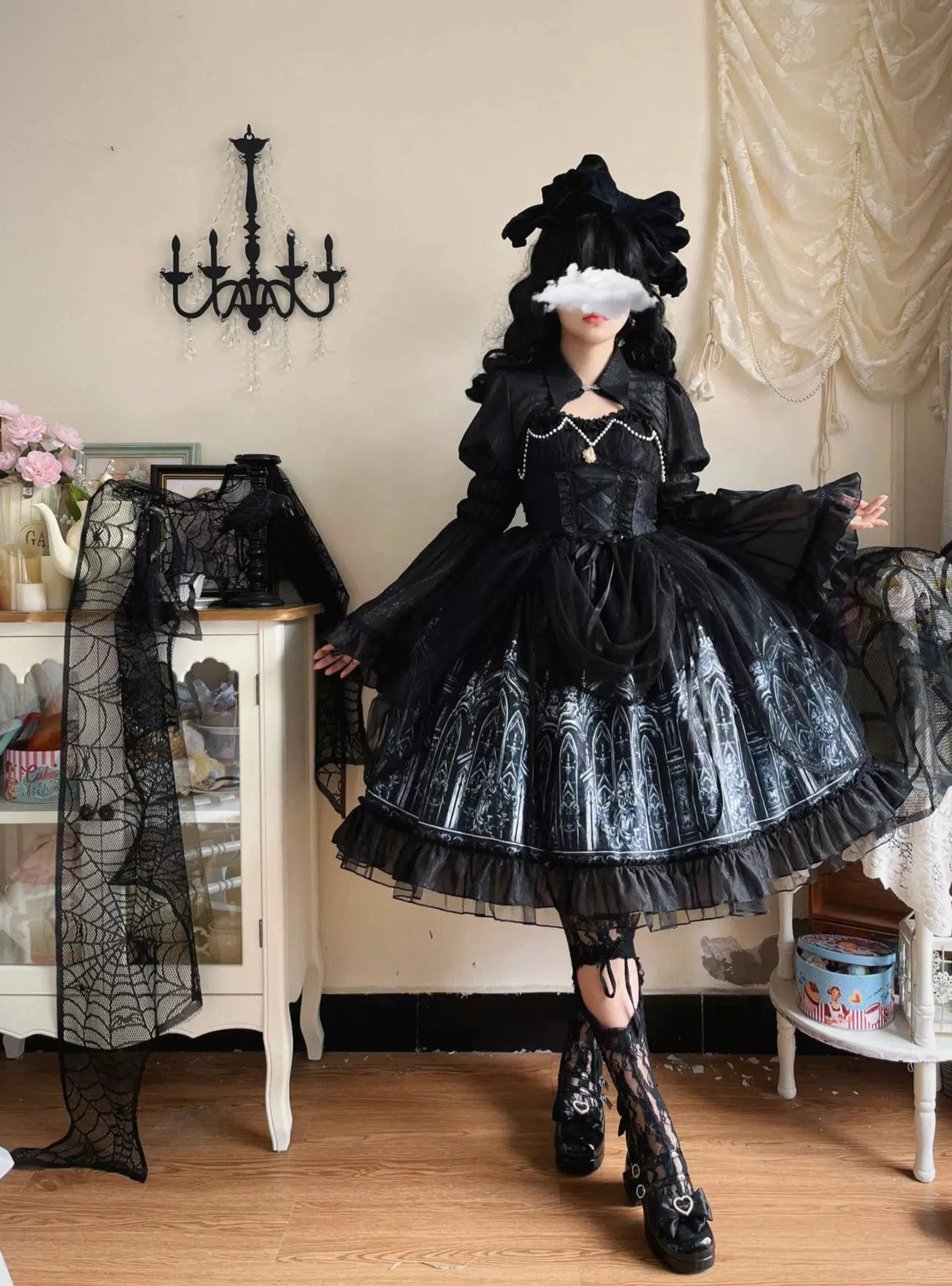 Model wearing complete Silent Night gothic lolita outfit including black JSK dress and bolero with silver cathedral print, paired with black bow headpiece, fishnet stockings and platform boots, full body front view