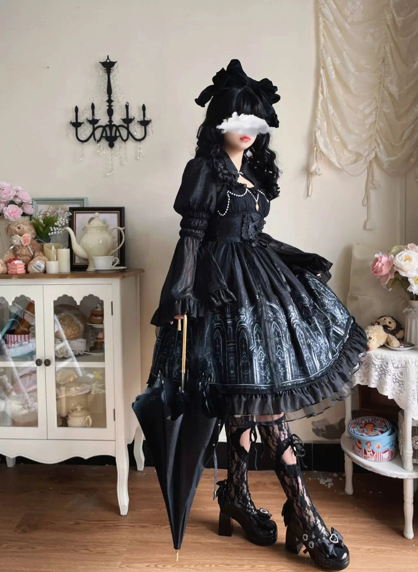 Model wearing Silent Night gothic lolita JSK dress in full body side profile view, carrying closed black parasol, displaying silver cathedral print and structured silhouette clearly