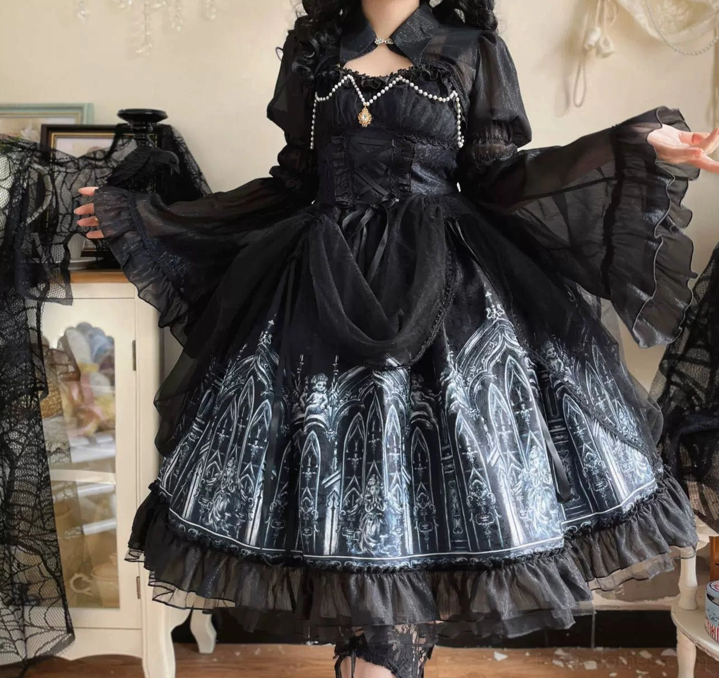 Half-body close-up three-quarter view of Silent Night gothic lolita dress featuring sheer ruffled trumpet sleeves, layered ruffled hem construction, and detailed silver cathedral print on black base