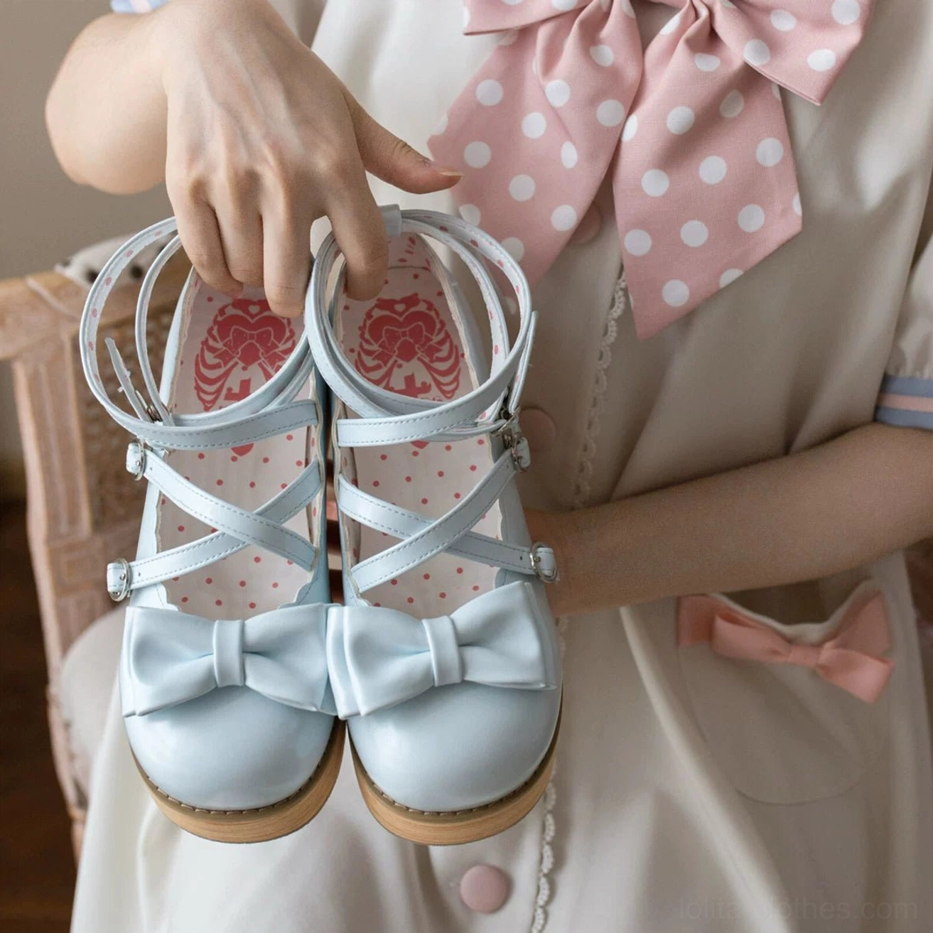 Silver metallic lolita platform shoes close up product shot smooth leather finish bow ankle strap buckle adjustable mechanism round closed toe styling detail