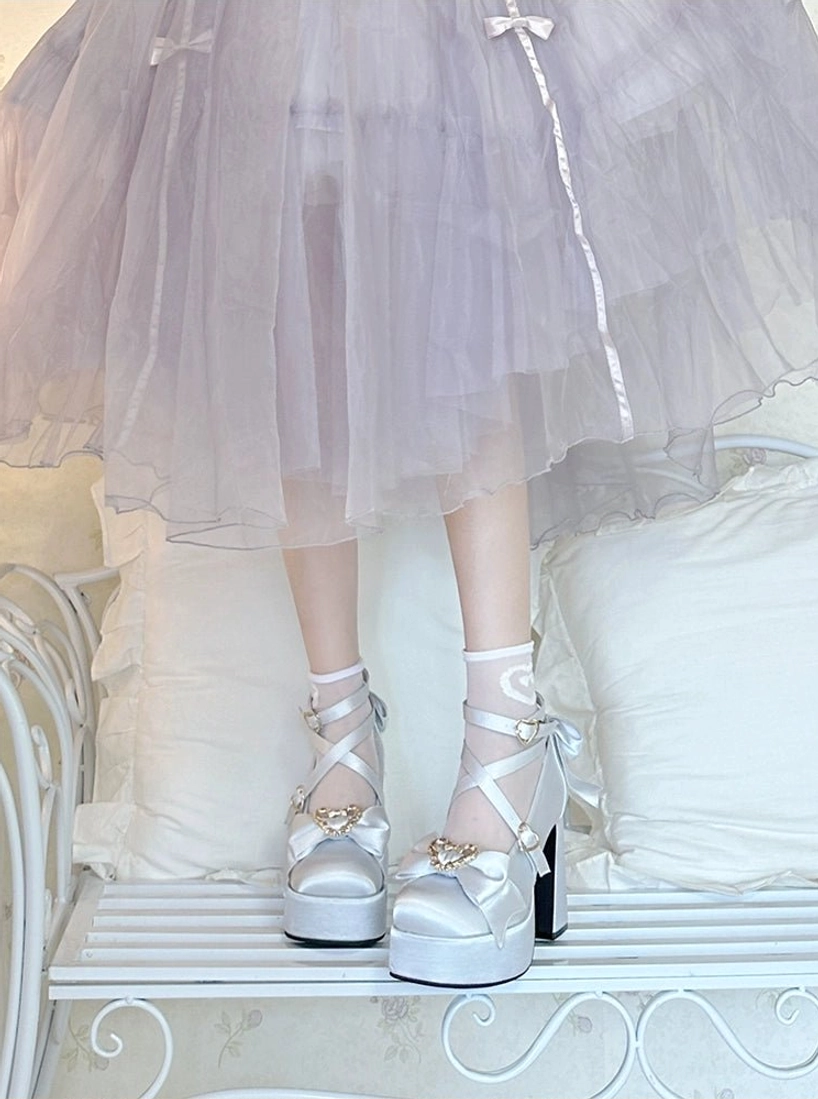 Silver Sweet Lolita Mary Jane heels on model legs low angle view wearing purple lolita skirt on white wrought iron bench
