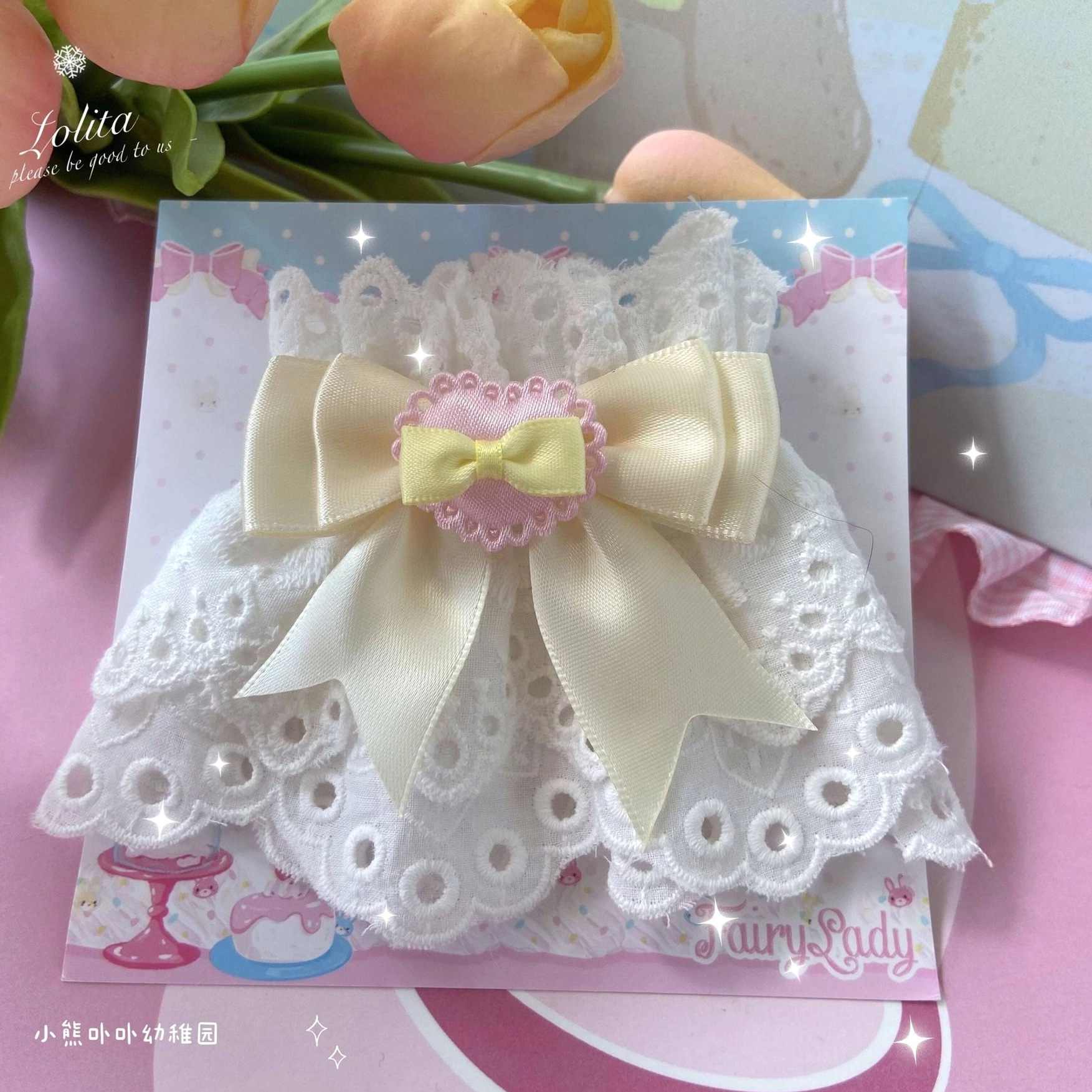 single lace wrist cuff with cream satin bow heart decoration on dessert themed printed backing card