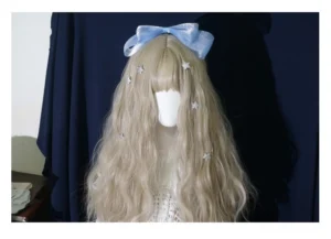 Single side bow lolita hair accessory with sky-blue shiny organza bow and star decoration on mannequin with light blonde curly hair