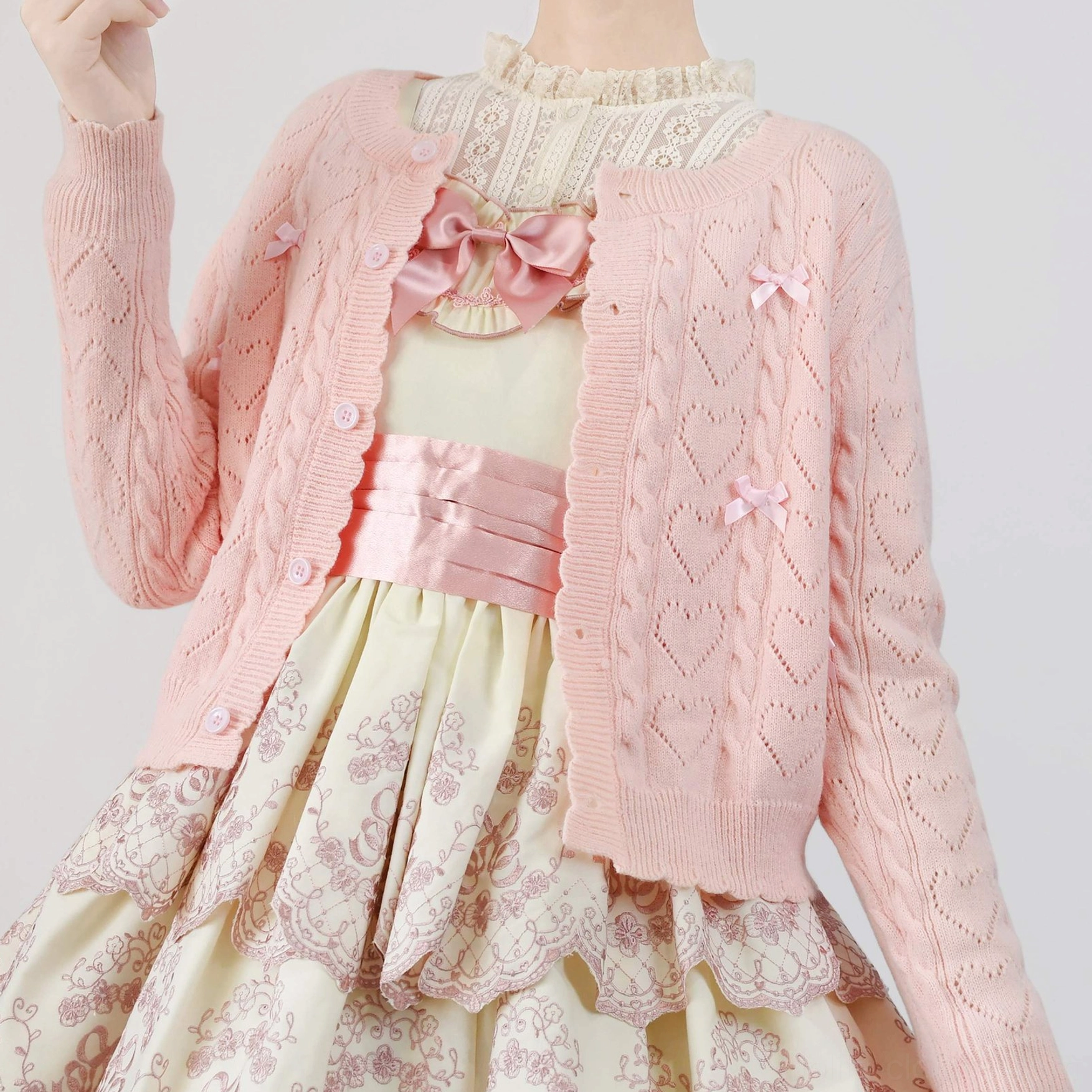 Size 2XL dark brown hollow out Lolita cardigan on model, showing roomier fit for plus-size Lolita fashion