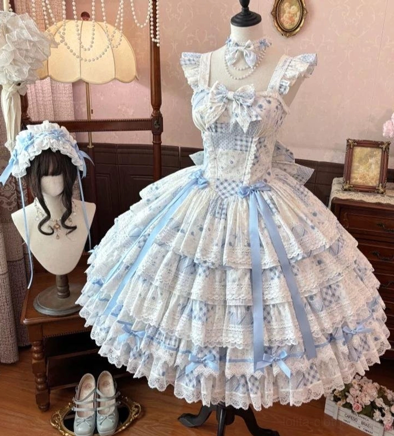 Front mannequin display of sky blue floral lolita JSK dress with blue satin ribbon trims, ditsy floral print, delicate bow neckline, and blue hair accessory