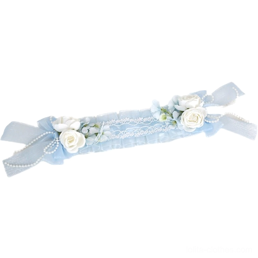 Sky blue lolita floral headband horizontal flat lay view showing ruffled chiffon lace artificial roses ribbon bows and pearl trims