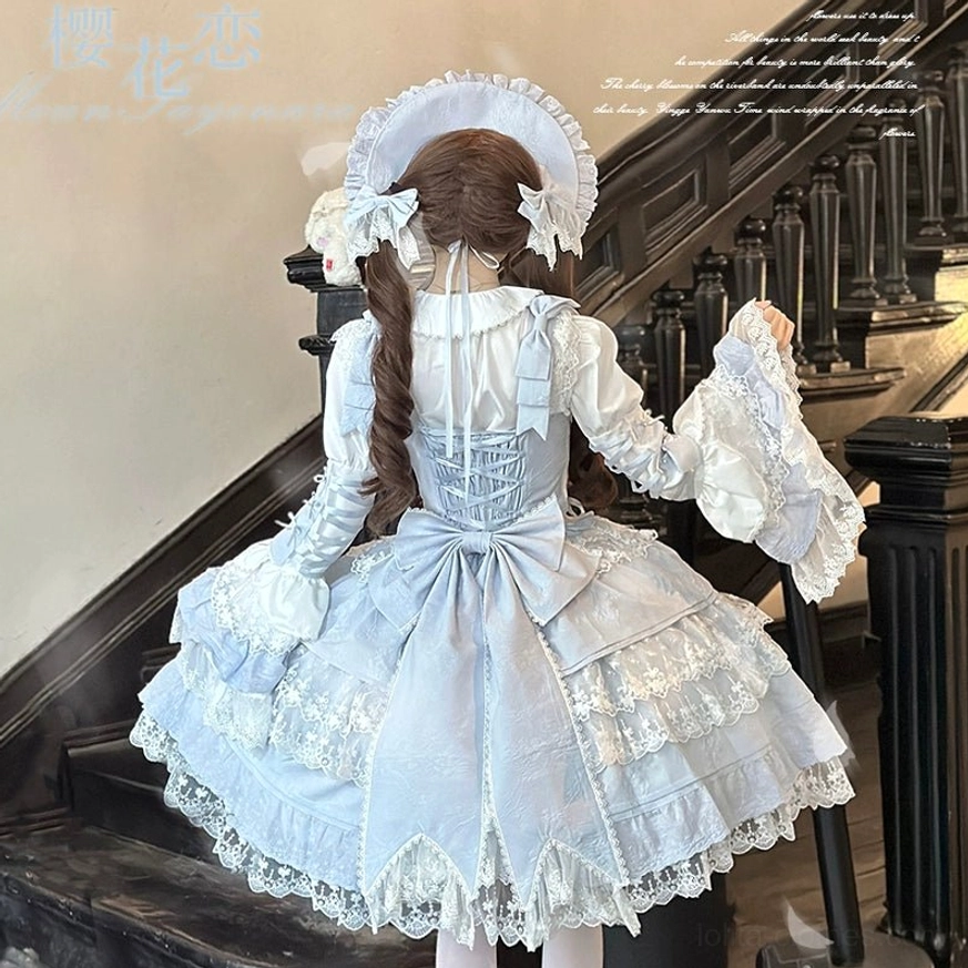 Sky blue Sakura Love lolita dress suit back view with exposed corset back design, layered lace skirt tiers, large back statement bow, matching fancy bonnet, marble staircase background