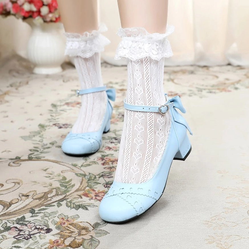 Sky blue sweet lolita Mary Jane round toe flat shoes with light blue ankle buckle strap and rear bow on model with ruffled lace ankle socks, vintage floral carpet styling