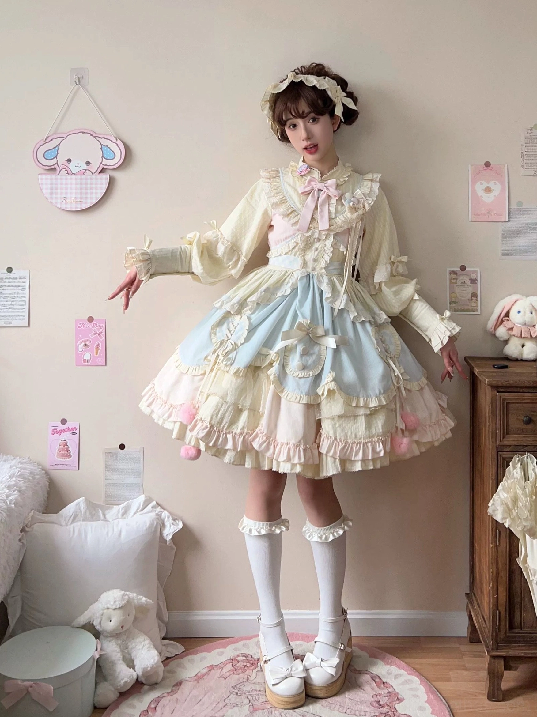 Full-body front standing view of sweet lolita OP dress featuring lace-trimmed long puff sleeves pink bow neck accessory white knee-high platform socks and loafers bedroom styling