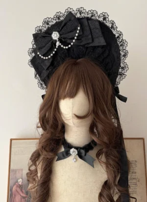 Black Gothic Lolita lace bonnet with pearl trim and satin bow displayed on mannequin with matching black choker
