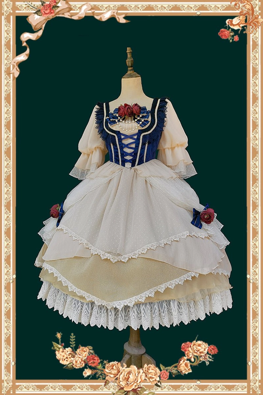 Snow White split-style Lolita OP dress on mannequin showing two-tone navy and cream design with multi-layered lace skirt, floral brooch on corset, and ruffled short sleeves against ornate vintage frame