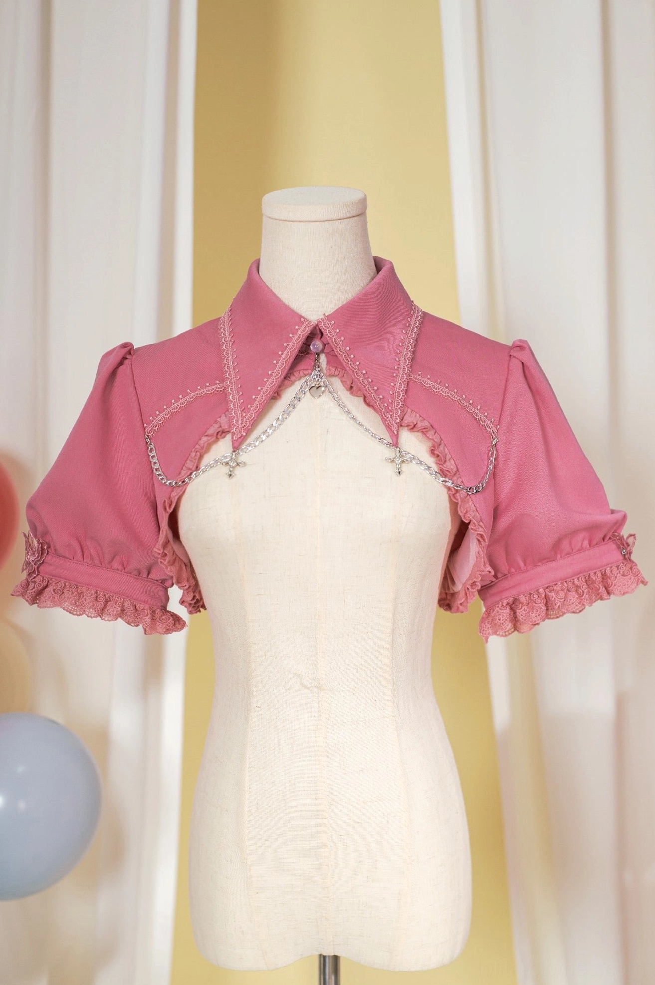 Soft rose pink gothic bubble sleeve bolero waistcoat with lace trim and cross chain embellishment