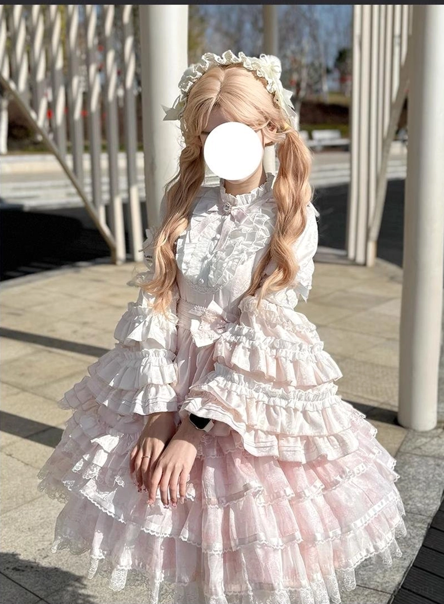 Pastel pink solo puppet sweet lolita OP dress front three-quarter outdoor street scene blonde curly twin hair lolita flower hair accessory multi-layered lace ruffles flared A-line skirt
