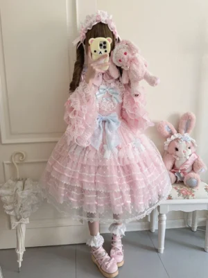 Spring Awakening Sweet Lolita JSK in pink with princess-sleeved bishop sleeve blouse, featuring heart-shaped lace bodice overlay, tiered tulle skirt, and sky-blue satin bow accents worn with matching pink hair accessory and pink platform lolita shoes