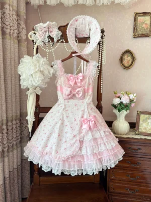 Spring Bud lolita jumper skirt with matching sweet aesthetic accessories displayed hanging, showcasing tiered lace hem, large front satin bow, paired with lace bonnet, decorative hair bows and pink lace parasol