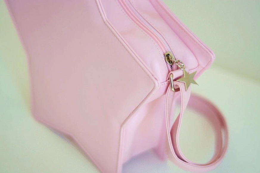 Close-up side view of pink star Lolita bag showing smooth PU leather material, metal zipper with star-shaped pendant accent, and premium texture detail