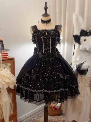Starlight Nocturne black lolita JSK with gold foil star and moon stamping displayed on mannequin, front view showing tiered ruffled skirt and square neckline