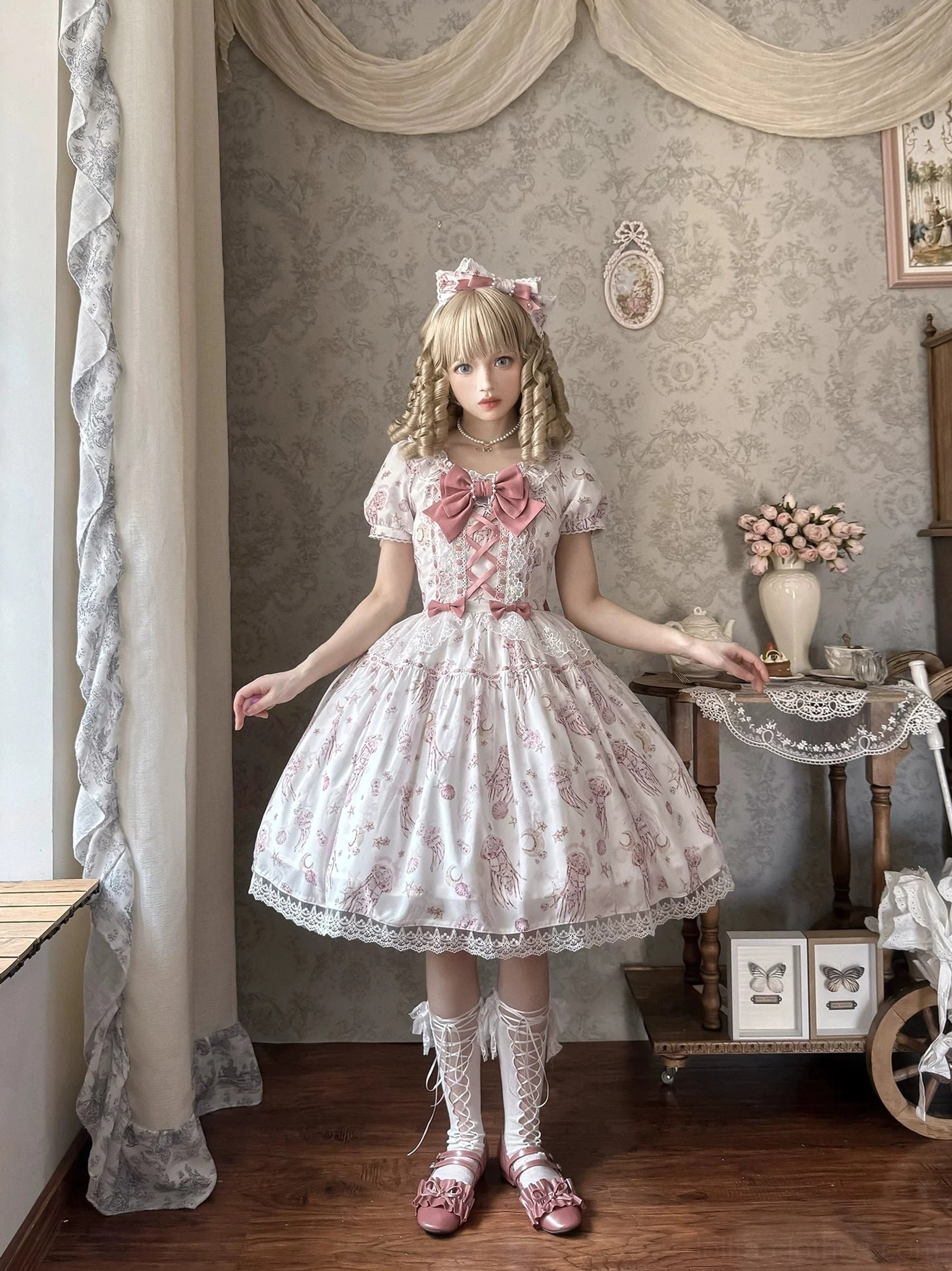 Starry jellyfish classic lolita short-sleeve OP dress front view light pink base celestial print tiered ruffled skirt contrast bow vintage aesthetic