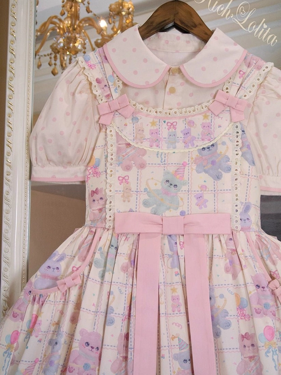 Starry pudding bear lolita jsk jumper skirt with double peter pan collars and pink bow hanging on wooden hanger