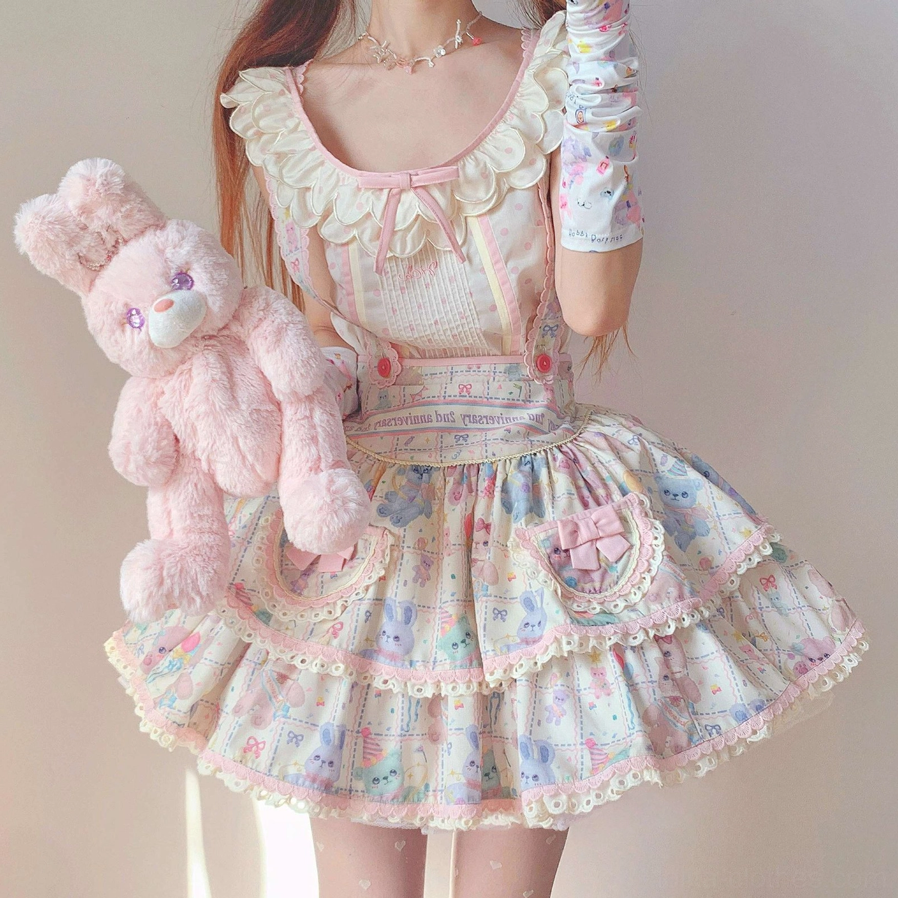 Close-up of starry pudding bear sweet lolita apron dress with ruffled neckline layered skirt and matching lace gloves