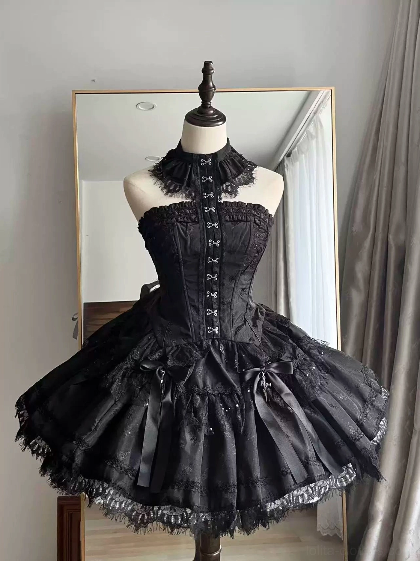 Black strapless gothic lolita corset with high lace choker neckline and cross front closures, layered mesh skirt with lace hem and cross charms, front full view mannequin